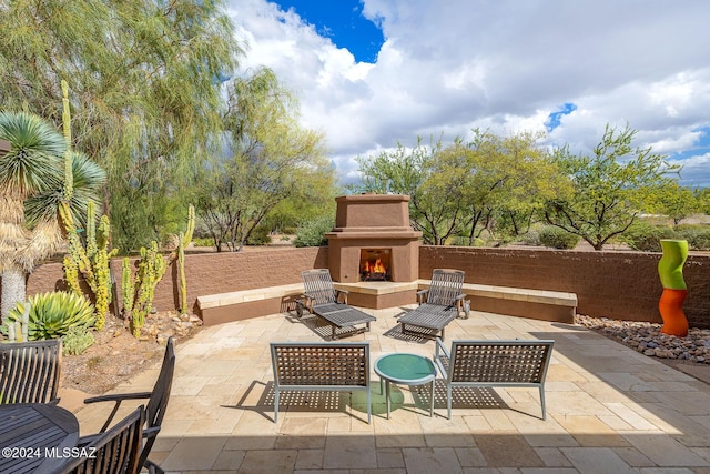 view of patio / terrace featuring exterior fireplace