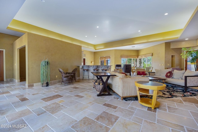 living room with a tray ceiling