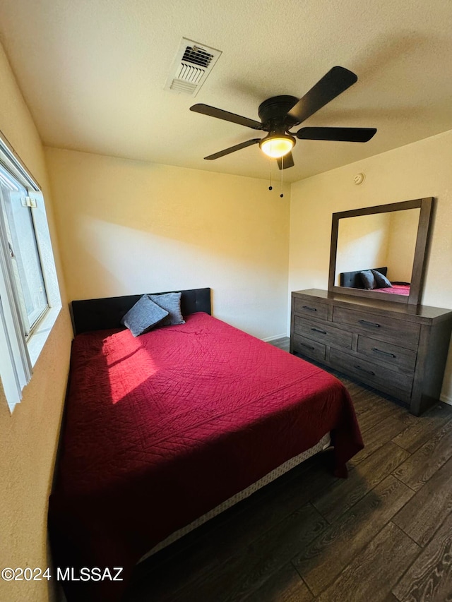 bedroom with ceiling fan and dark hardwood / wood-style flooring