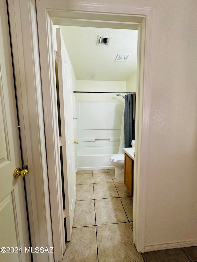 full bathroom featuring shower / bath combination with curtain, toilet, tile patterned floors, and vanity