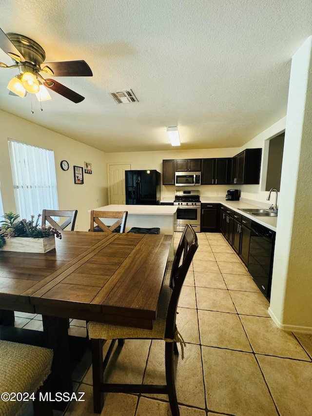 dining room with light tile patterned floors, sink, ceiling fan, and a textured ceiling