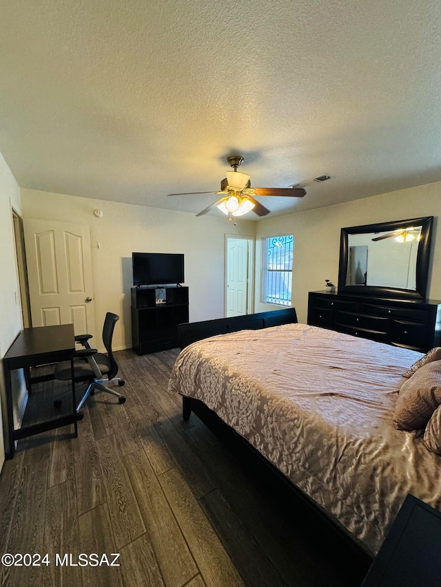 bedroom featuring ceiling fan, wood-type flooring, and a textured ceiling