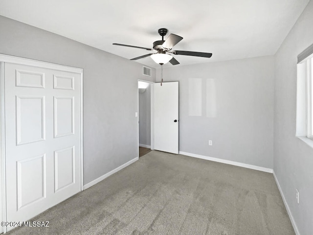 unfurnished bedroom with light carpet and ceiling fan