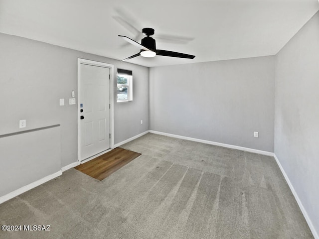 carpeted empty room featuring ceiling fan