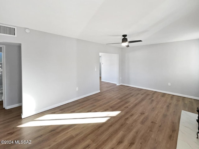 unfurnished room with dark hardwood / wood-style floors and ceiling fan