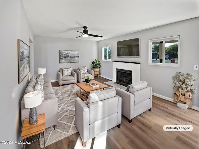 living room with ceiling fan, hardwood / wood-style floors, and a healthy amount of sunlight