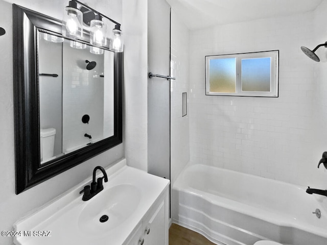 full bathroom featuring vanity, toilet, and tiled shower / bath