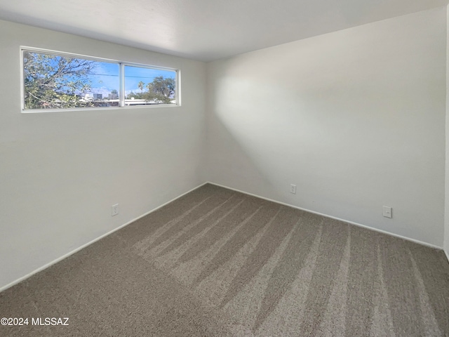 unfurnished bedroom featuring carpet floors, a textured ceiling, and a closet