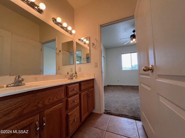 full bath with double vanity, a sink, tile patterned floors, and a ceiling fan
