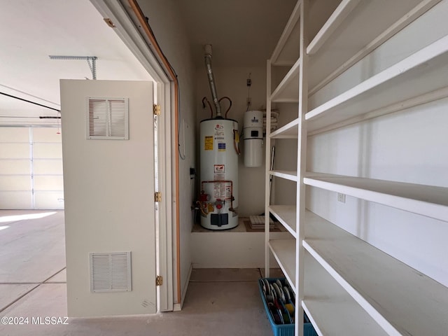 utility room featuring visible vents and gas water heater