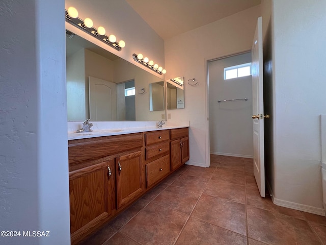 full bathroom featuring tile patterned floors, a sink, baseboards, visible vents, and double vanity