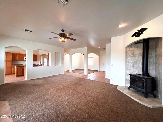 unfurnished living room with light colored carpet, visible vents, and a ceiling fan