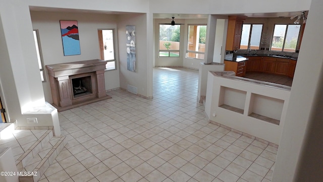 kitchen featuring sink, light tile patterned floors, and decorative backsplash