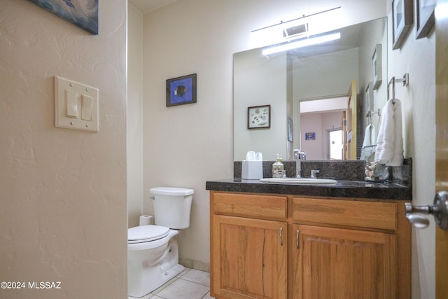 bathroom with vanity, tile patterned floors, and toilet