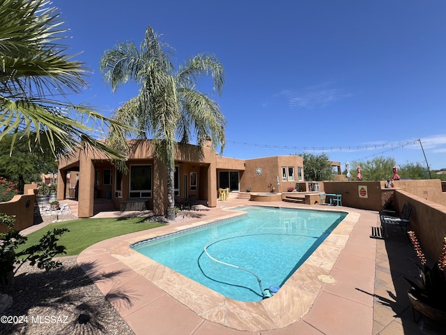 view of swimming pool featuring a patio area