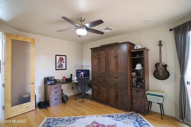 office space featuring ceiling fan and light hardwood / wood-style flooring