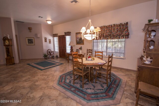 dining room with a chandelier and tile patterned floors