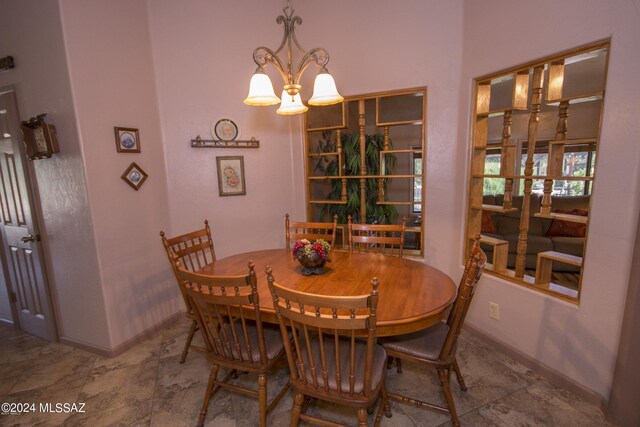 dining room with an inviting chandelier and tile patterned flooring