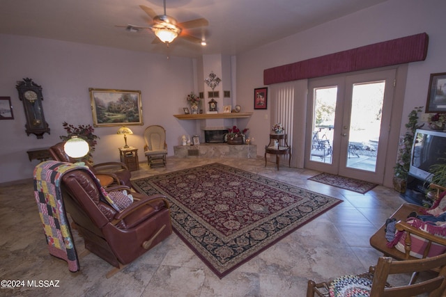 tiled living room featuring french doors and ceiling fan