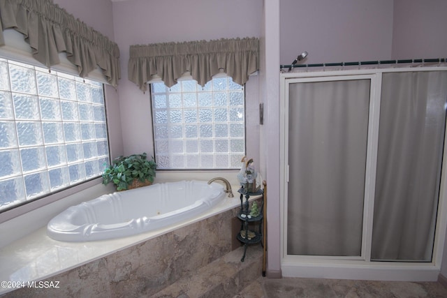 bathroom with independent shower and bath and tile patterned floors