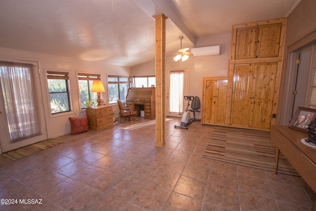 tiled foyer entrance featuring a stone fireplace, a wall mounted AC, ceiling fan, and vaulted ceiling