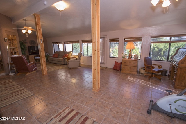 unfurnished living room featuring tile patterned flooring, lofted ceiling, and ceiling fan