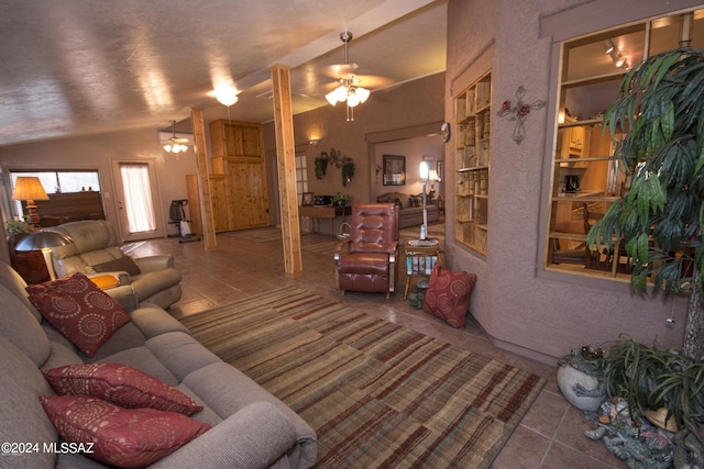 living room with tile patterned flooring, ceiling fan, lofted ceiling, and built in shelves