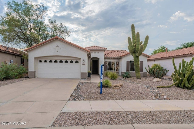 mediterranean / spanish house featuring a garage