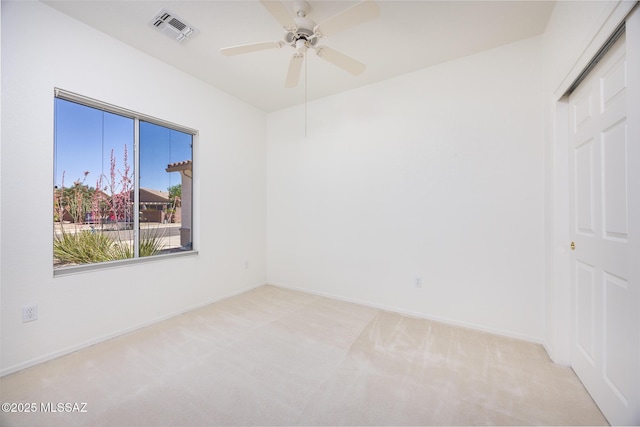 unfurnished bedroom with a ceiling fan, baseboards, visible vents, and light carpet