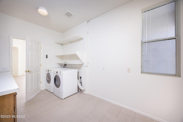 laundry room with independent washer and dryer, laundry area, visible vents, and baseboards