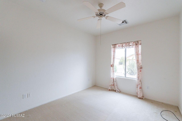 empty room featuring ceiling fan and carpet floors