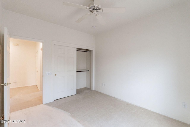 bedroom featuring ceiling fan, light colored carpet, and a closet