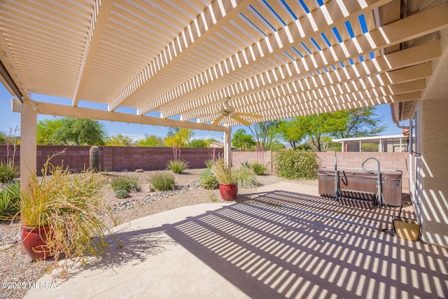 view of patio / terrace featuring a fenced backyard, a ceiling fan, a pergola, and a hot tub