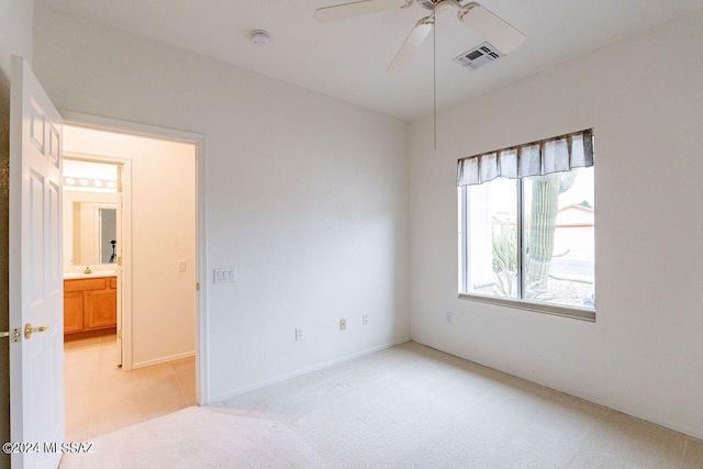 unfurnished room featuring light carpet and ceiling fan