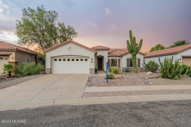 mediterranean / spanish home with a garage