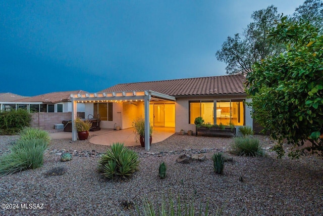 rear view of property featuring a patio and a pergola