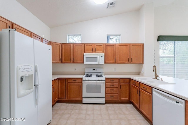 kitchen featuring sink, white appliances, and high vaulted ceiling