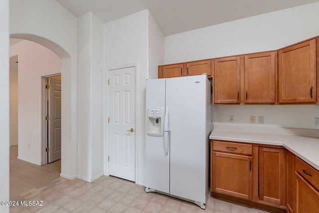 kitchen featuring white fridge with ice dispenser