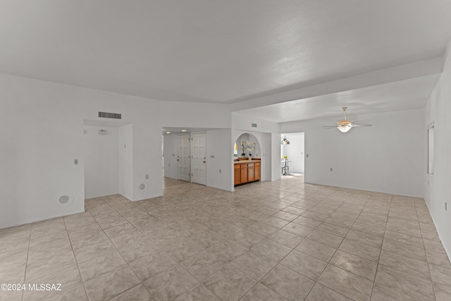 unfurnished living room with ceiling fan