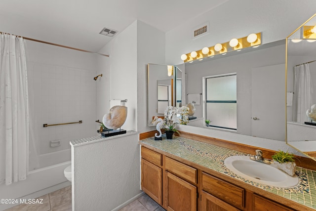 full bathroom featuring vanity, toilet, tile patterned flooring, and shower / bath combo with shower curtain