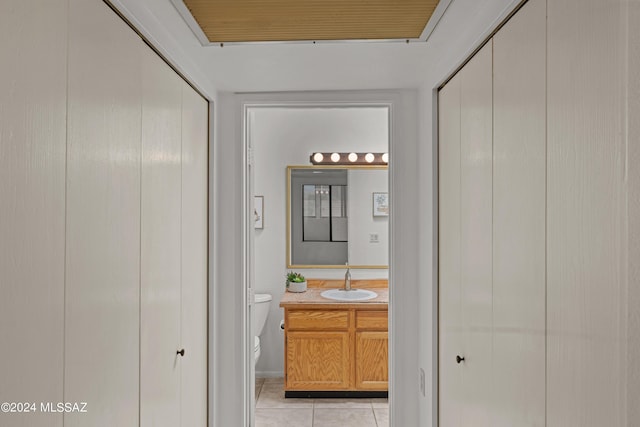 bathroom with vanity, toilet, and tile patterned flooring