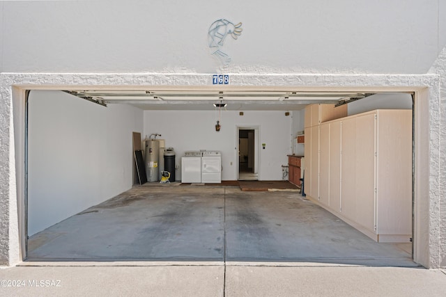 garage featuring independent washer and dryer and water heater