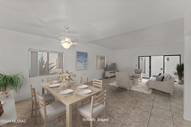 tiled dining room featuring lofted ceiling and ceiling fan