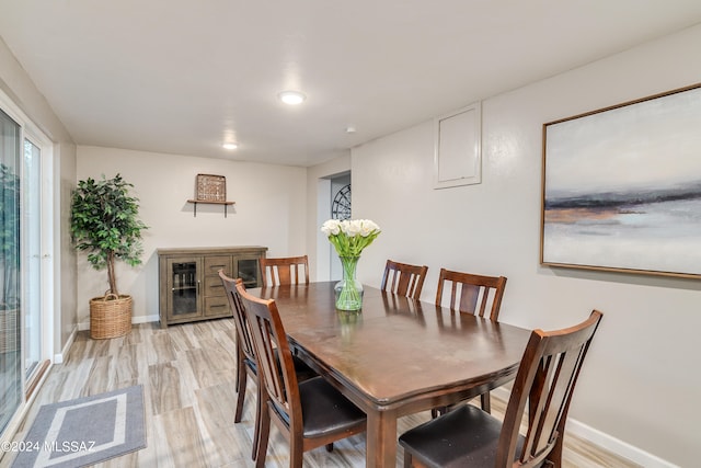 dining space with light wood-type flooring