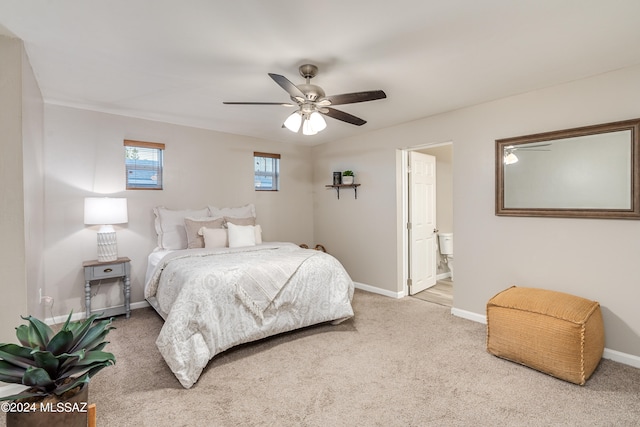 carpeted bedroom featuring ceiling fan and ensuite bathroom