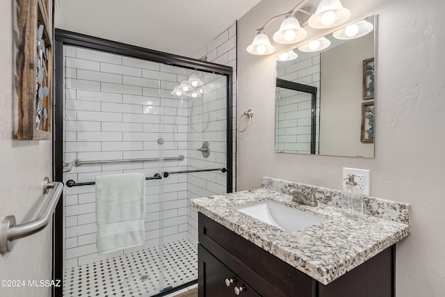 bathroom featuring walk in shower and vanity