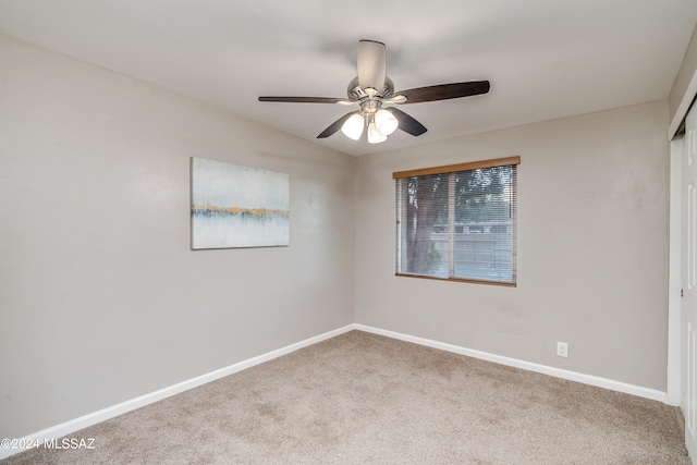 empty room with ceiling fan and carpet