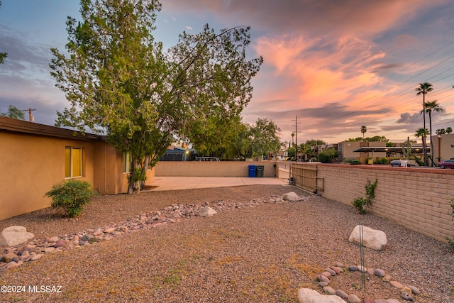 yard at dusk with a patio