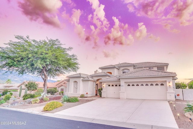 mediterranean / spanish-style home featuring a garage