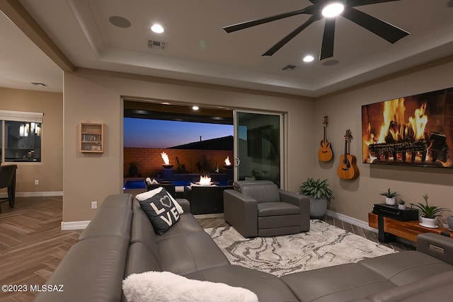 cinema featuring visible vents, baseboards, and a tray ceiling